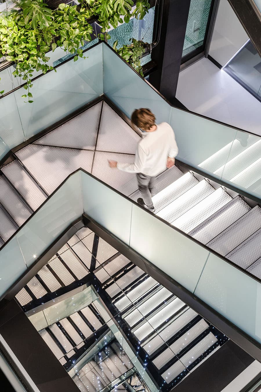 Backlit translucent stair treads in a multi-level atrium