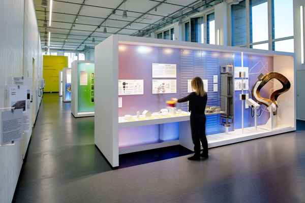 Backlit honeycomb panels glowing purple and blue behind an exhibit